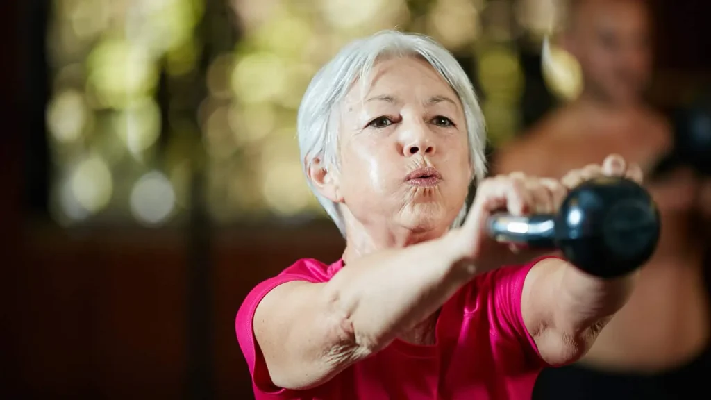 Toning Arms Without the Bulk: Is It Achievable? 1 Woman doing resistance band exercises for toned arms Braintree