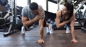 Image of man and woman doing Cardio Braintree to tone their arms. 